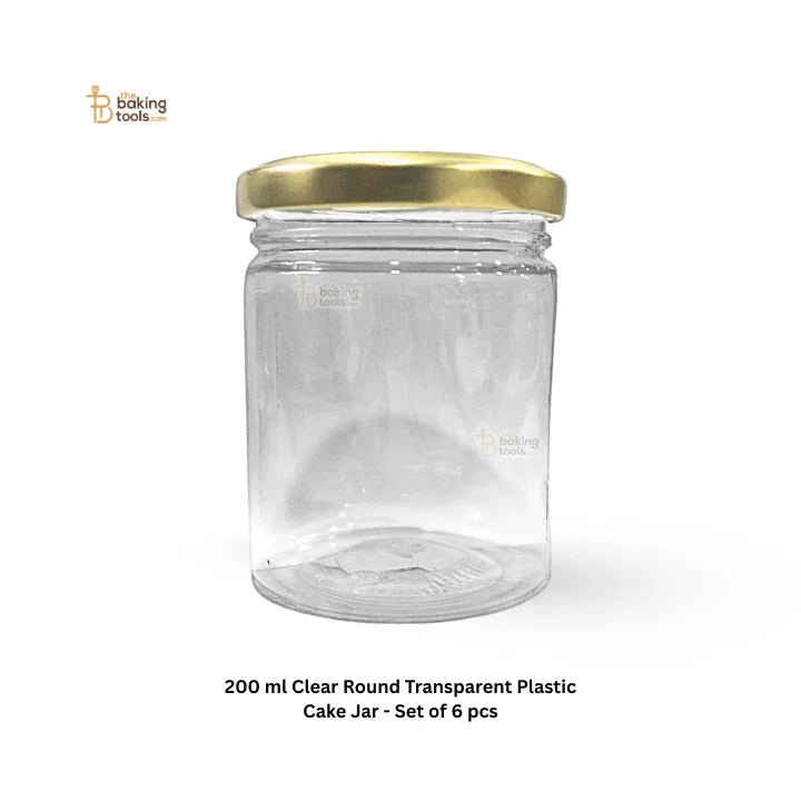 Clear round transparent plastic cake jar with gold lid on a white background