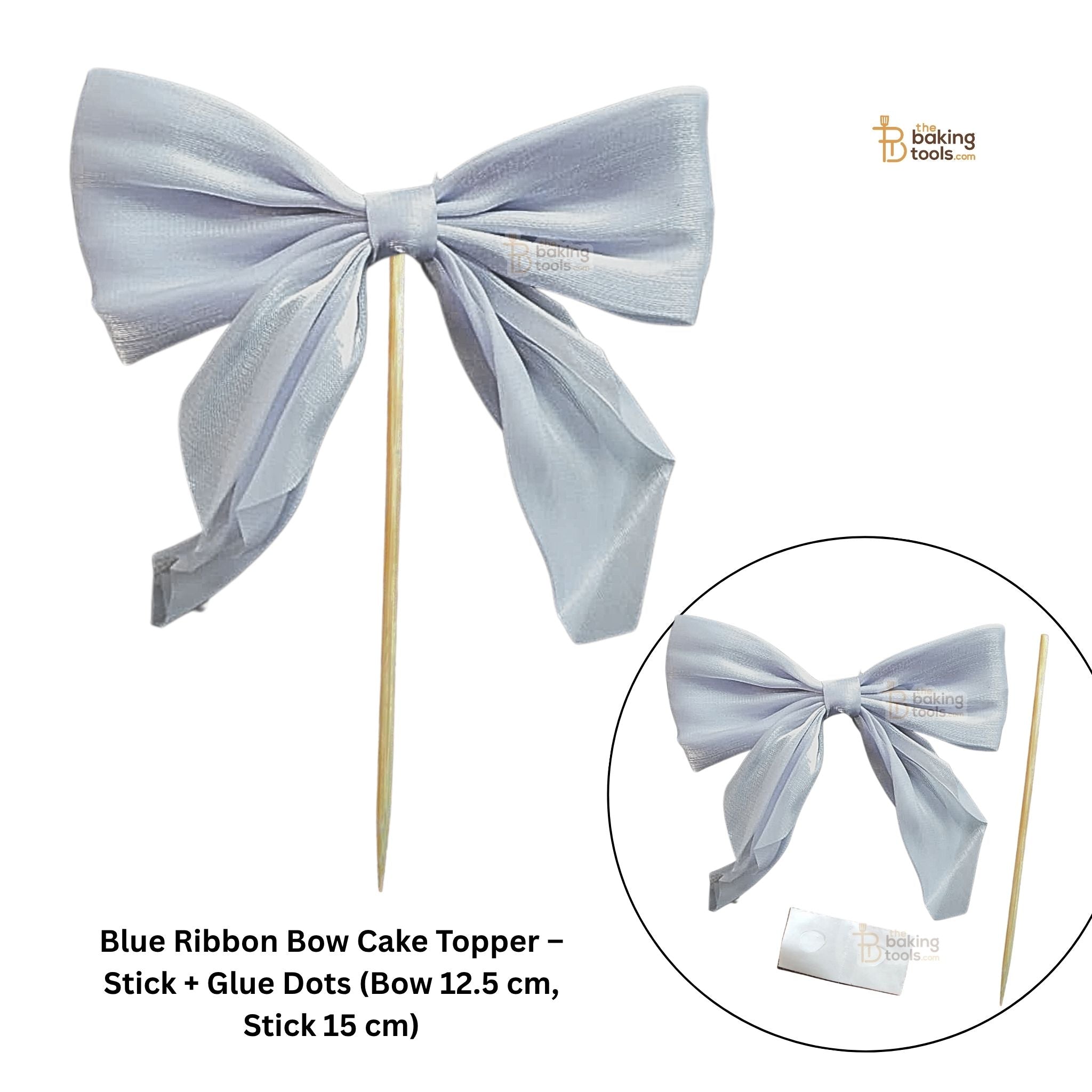 Blue ribbon bow cake topper with stick and glue dots on a white background