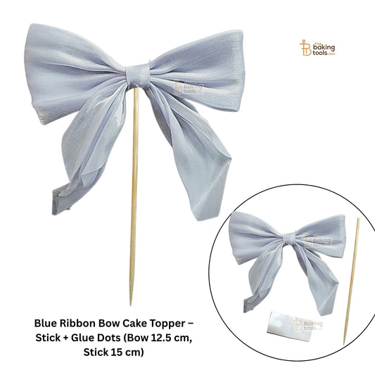 Blue ribbon bow cake topper with stick and glue dots on a white background