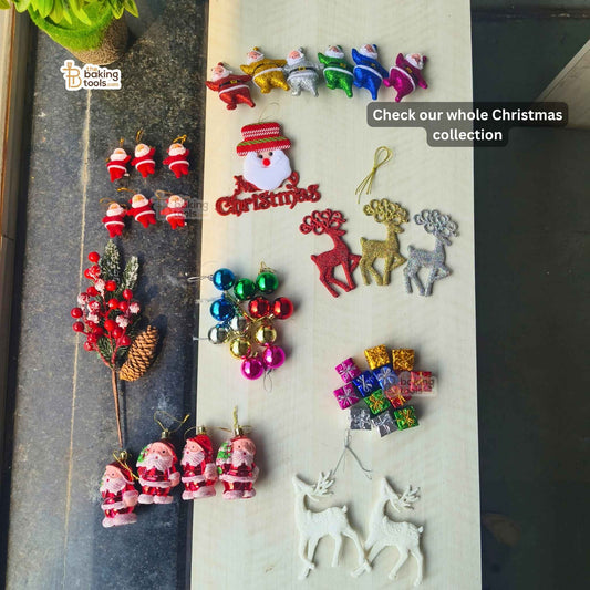 Collection of colorful Christmas-themed decorations on a marble surface.