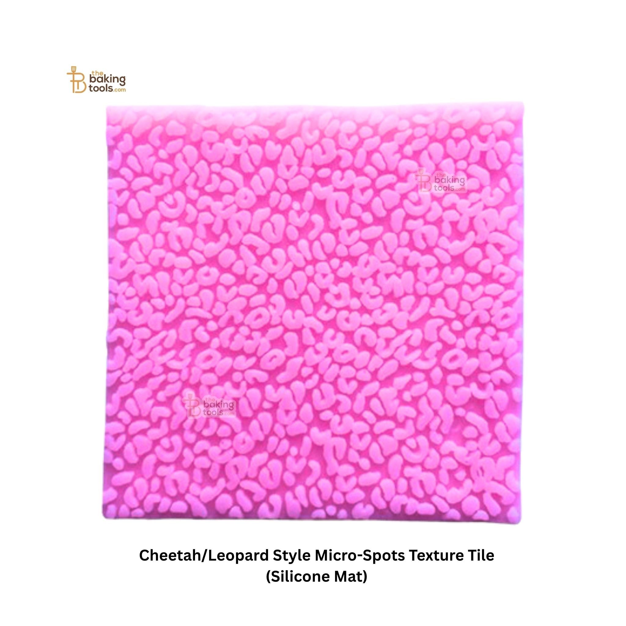 Pink silicone mat with cheetah/leopard style micro-spots texture on a white background