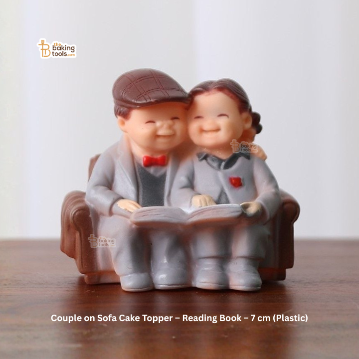 Couple on sofa cake topper reading a book