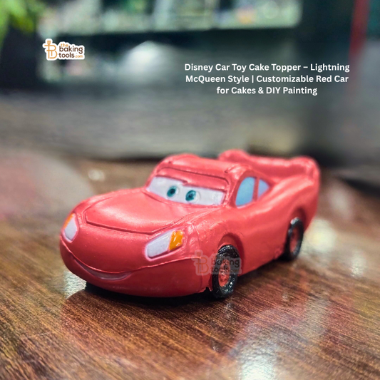 Red toy car with facial features on a wooden surface, branded 'baking tools'.