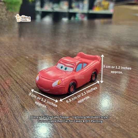 Red toy car with dimensions on a wooden surface, featuring Disney branding.