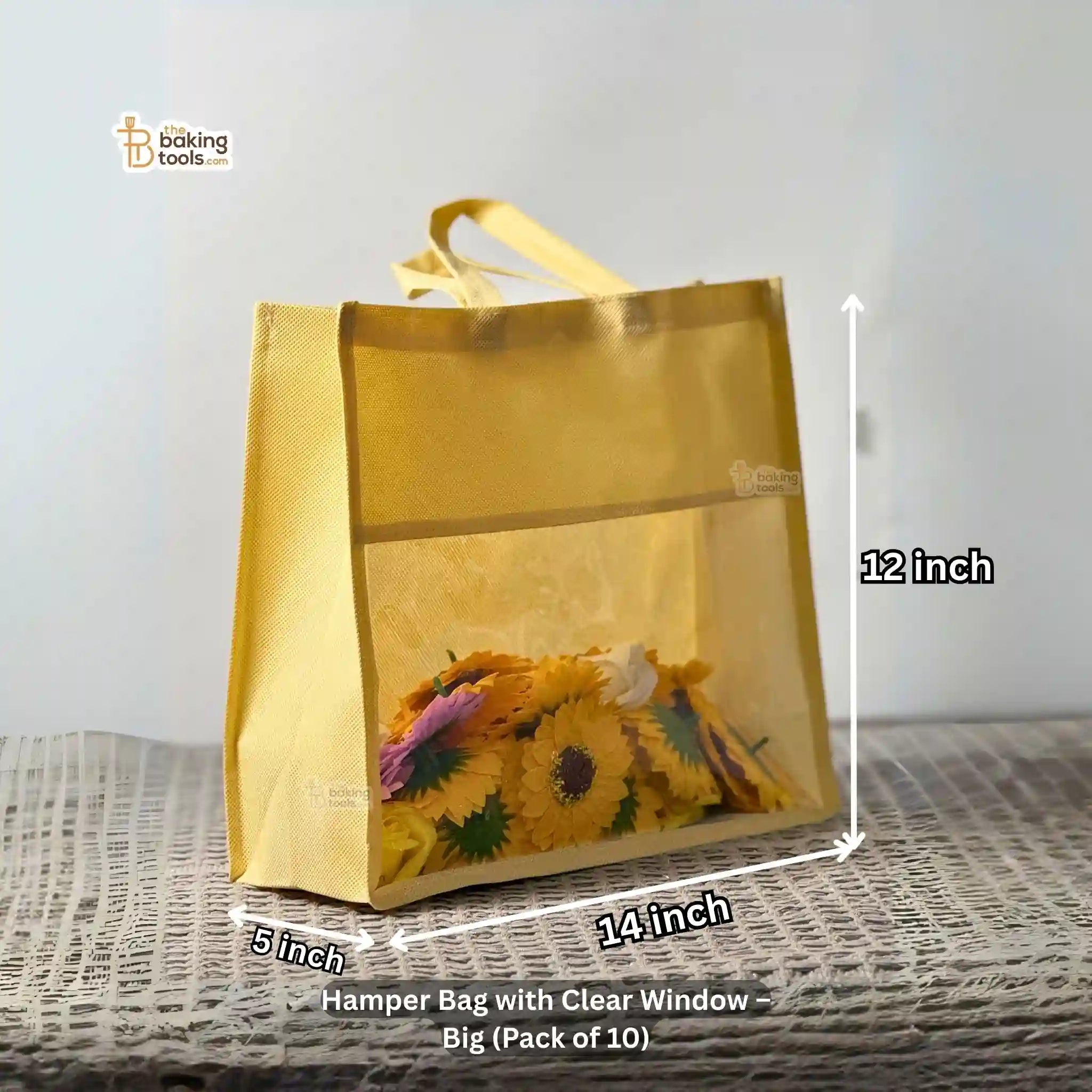 Hamper bag with clear window and floral design, shown with measurements 12 by 14 by 5 inches, on a textured surface.