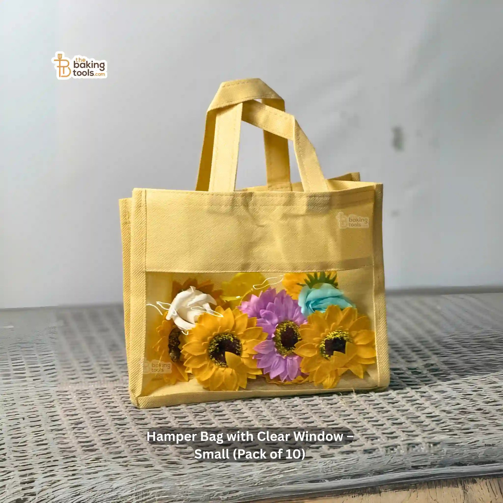 Yellow hamper bag with clear window containing flowers 