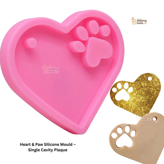 Pink heart-shaped silicone mould with paw print design on a white background