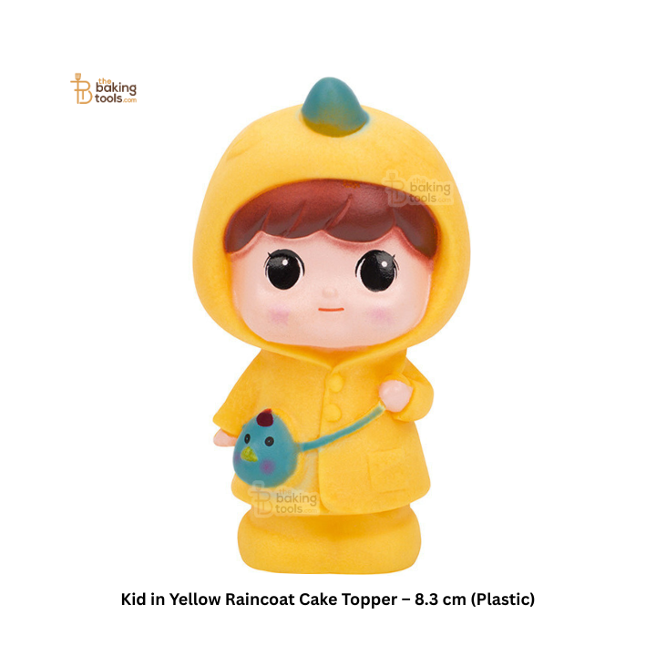 Cake topper of a child in a yellow raincoat holding a blue bird bag