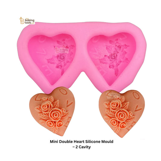 Pink double heart silicone mold with floral designs on a white background