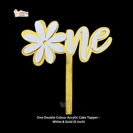 Acrylic cake topper with white flower and 'one' text in gold on a black background