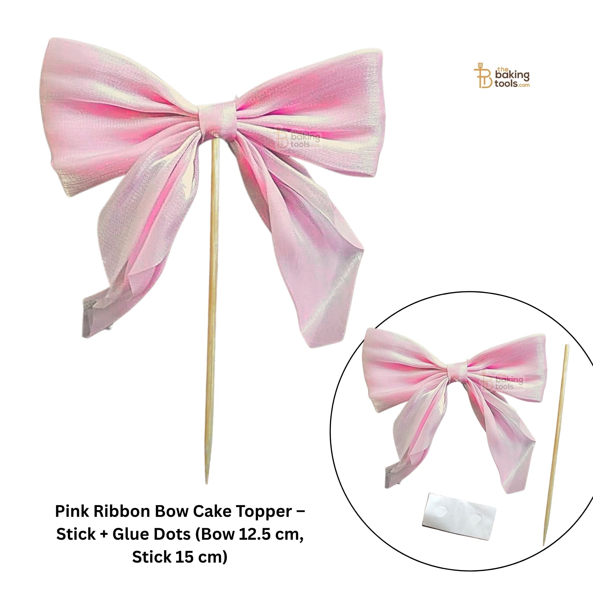 Pink ribbon bow cake topper with stick and glue dots on a white background