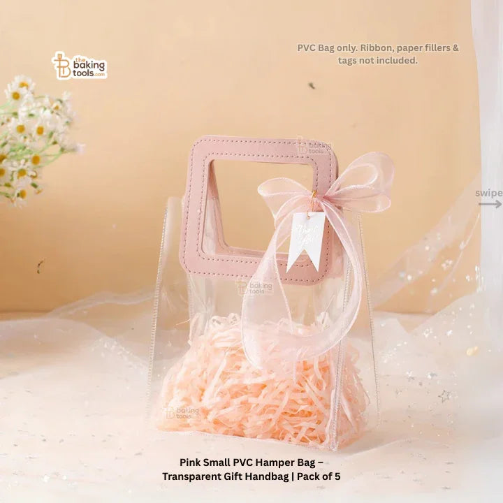 Pink small PVC hamper bag with a handle and ribbon on a beige background