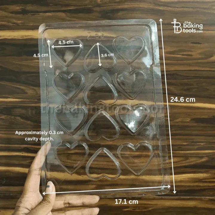 Heart-shaped mold with measurements on a wooden background
