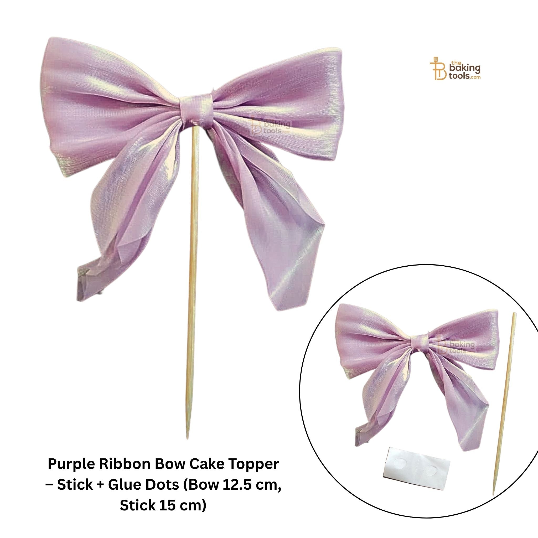 Purple ribbon bow cake topper with stick and glue dots on a white background