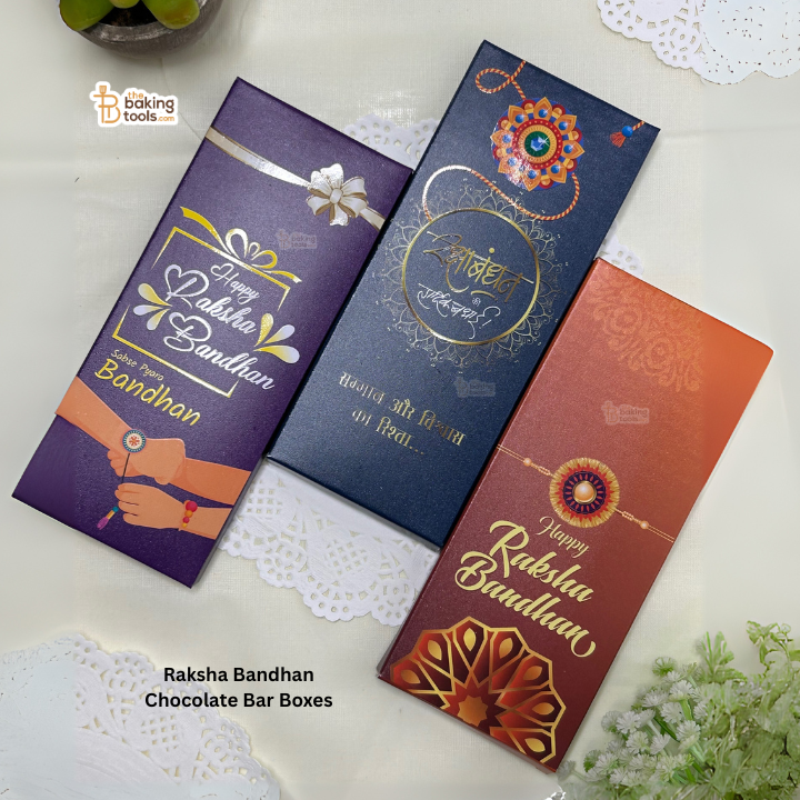 Three Raksha Bandhan-themed chocolate bar boxes on a white surface with decorative elements.