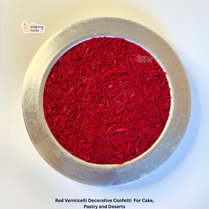 Red vermicelli decorative confetti in a metal container with 'Baking Tools' branding.