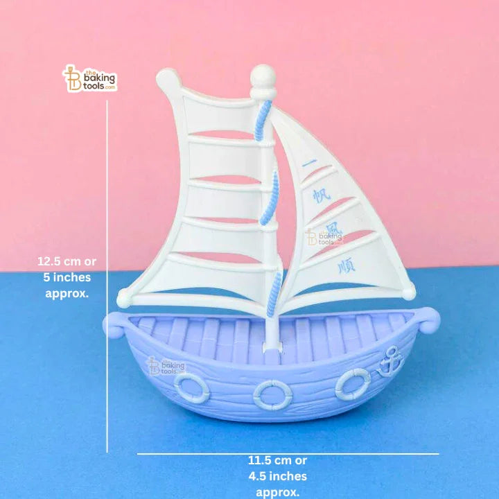 Sailboat-shaped mold on a blue and pink gradient background with measurements indicated.