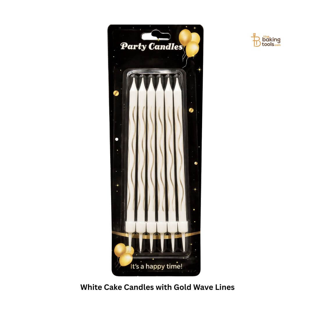 white cake candles with gold wave line pattern