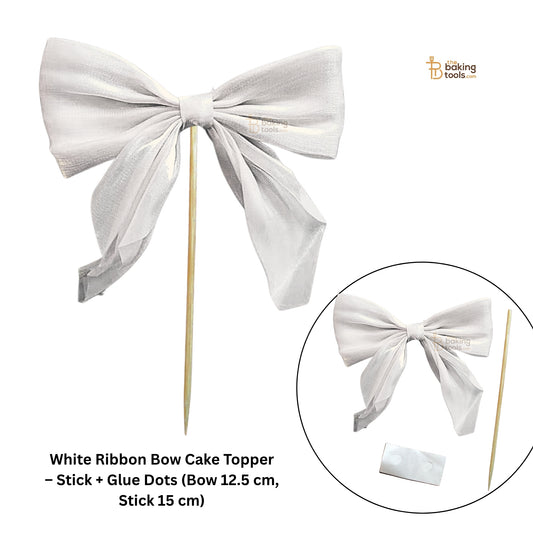 White ribbon bow cake topper with stick and glue dots on a white background