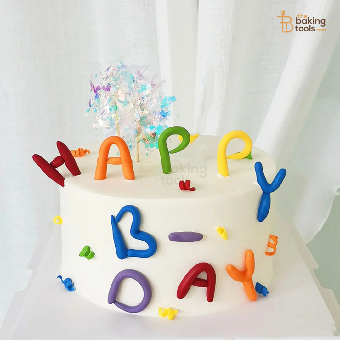 White cake with colorful 'HAPPY BIRTHDAY' letters on a white background